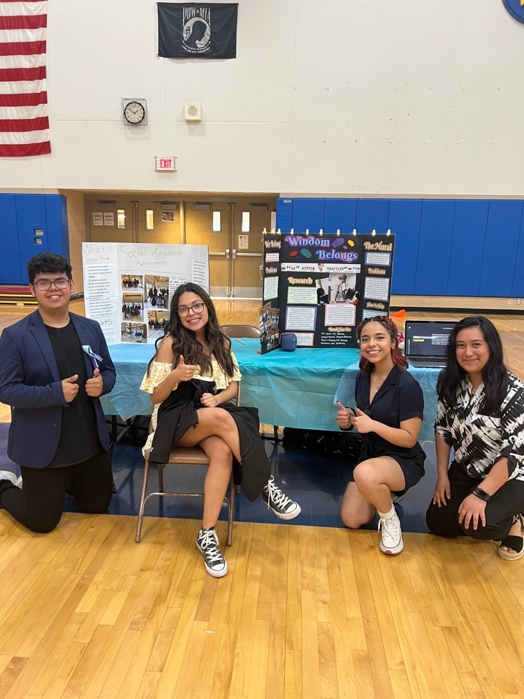 students giving thumbs up with projects